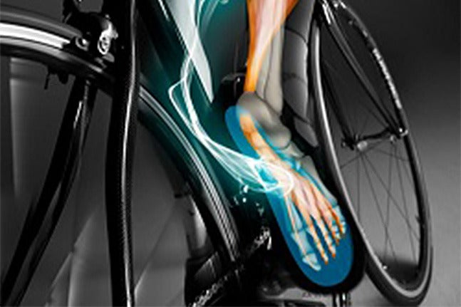 Bicycle with a detailed view of a foot wearing a mountain bike shoe on a gray background
