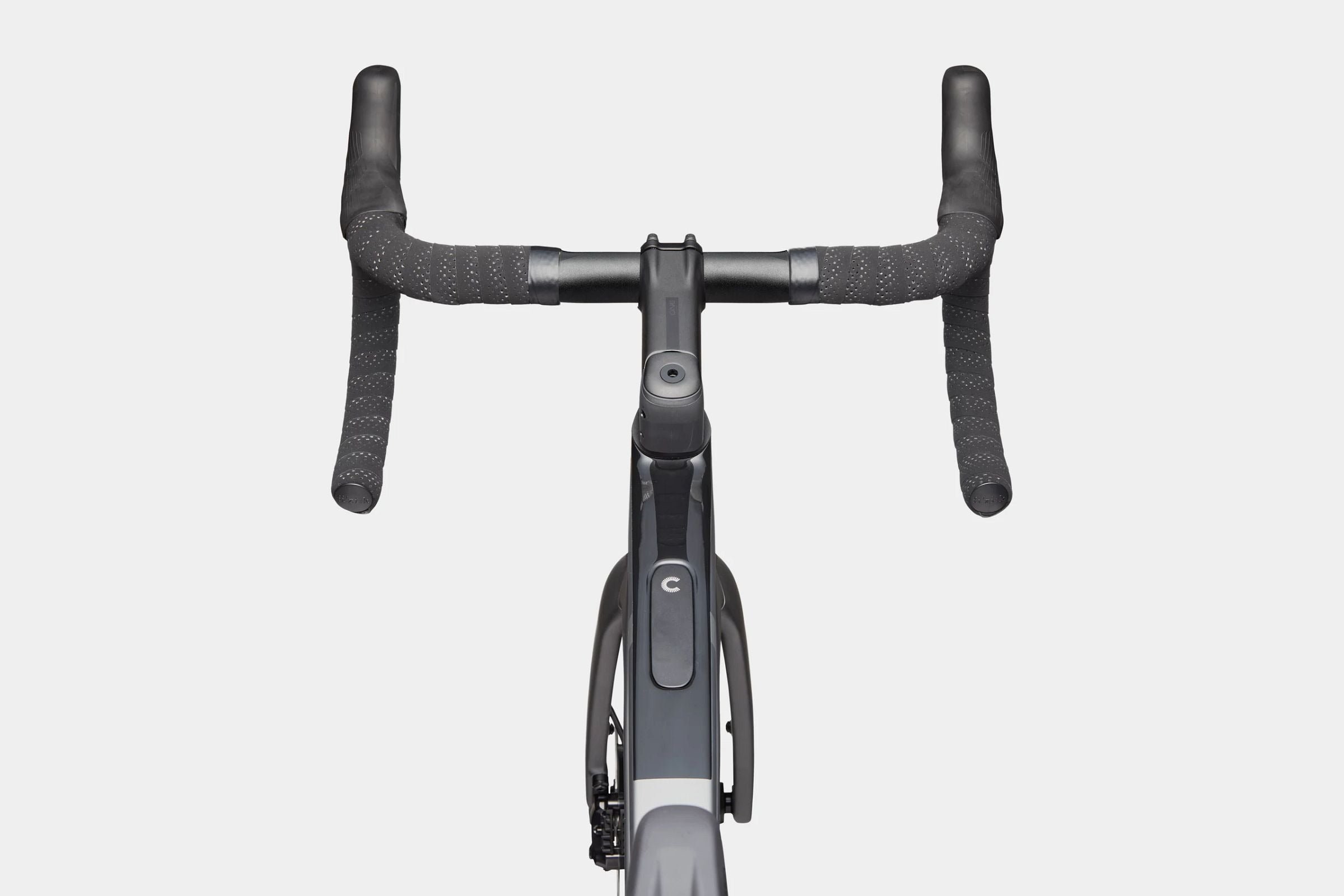 Aerial view of a road bike handlebar with black bar tape on a light gray background