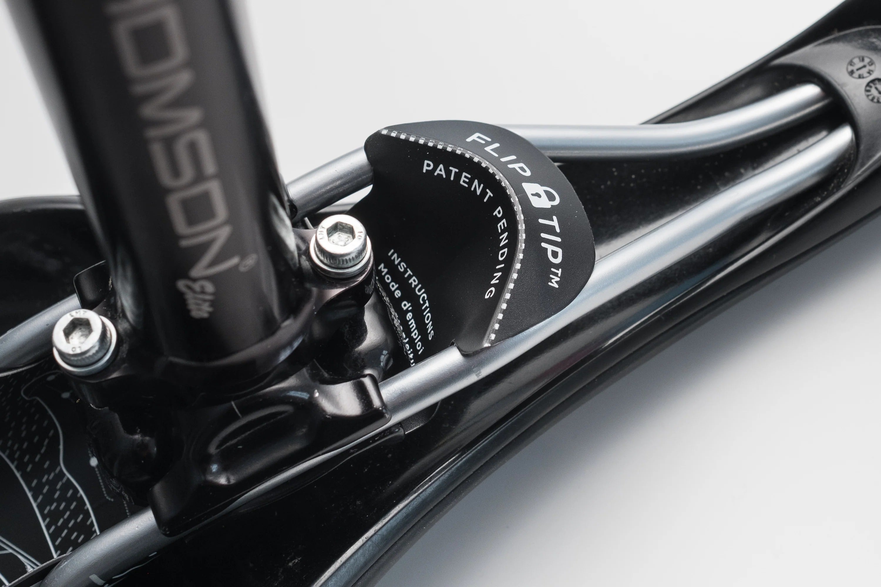 A close up of the underneath of a saddle showing the mounting of an Ass Saver Rear Fender against a white background