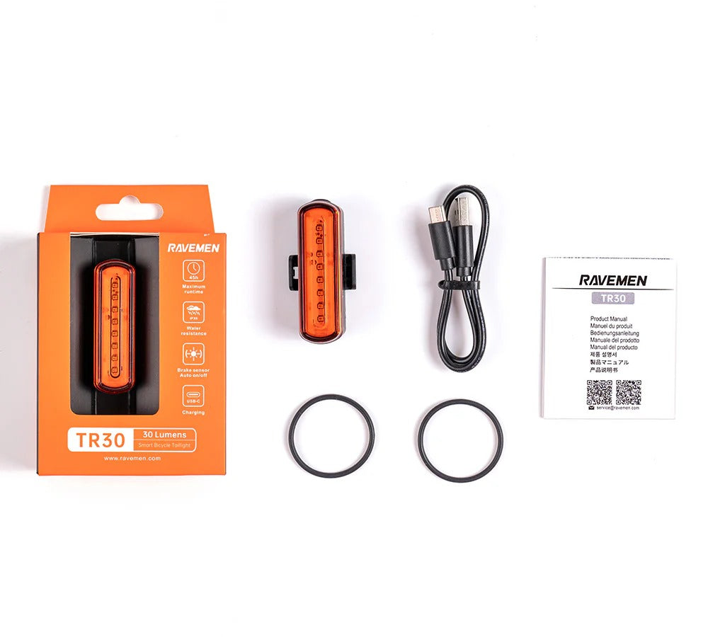 Ravemen TR30 bike light set with packaging, light, cable, and user manual on a white background