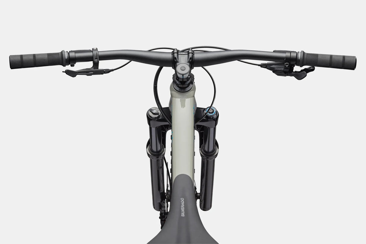 Close up of a grey mountain bike handlebar and top tube on a white background