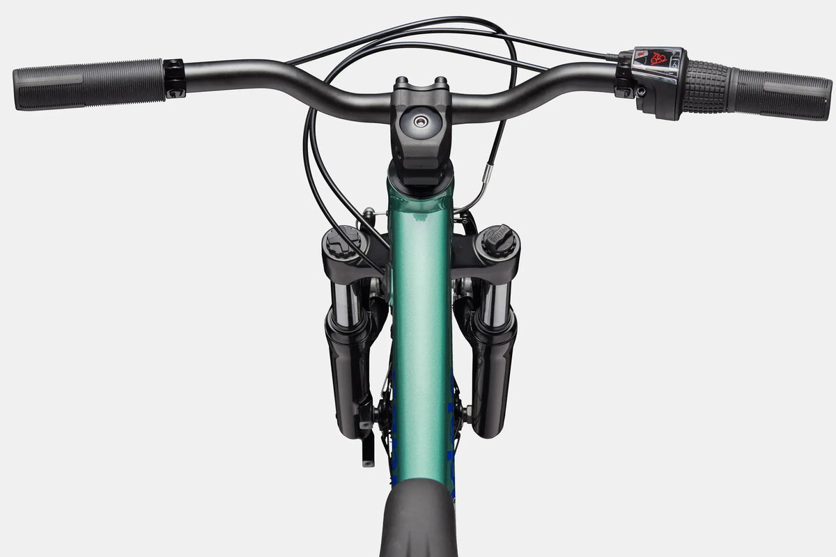 A close up of the handlebars and top tube of a green kids mountain bike on a white background