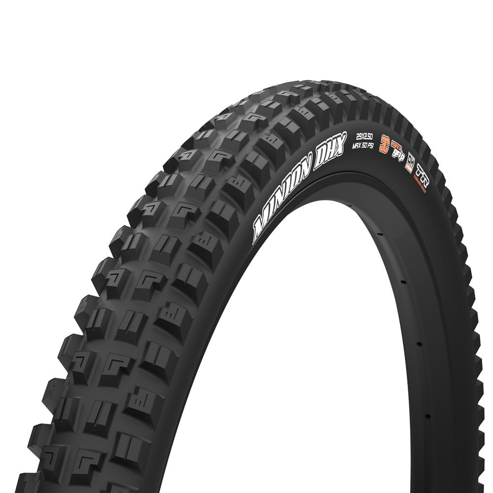 A black mountain bike tyre with aggressive tread, shown at a three-quarter angle on a light gray background. The sidewall features white branding text reading 'Minion DHX' and small orange and white technical specifications.