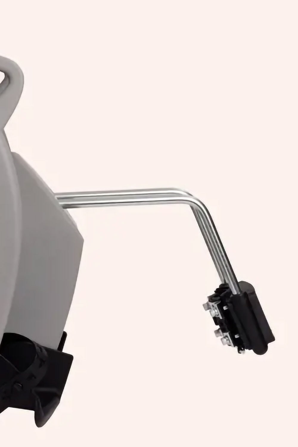 A close up of a bracket attached to a grey baby seat on a white background