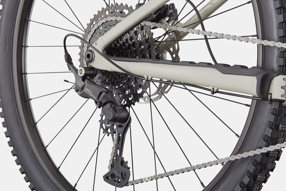 Close up of  the rear cassette on a grey mountain bike on a white background