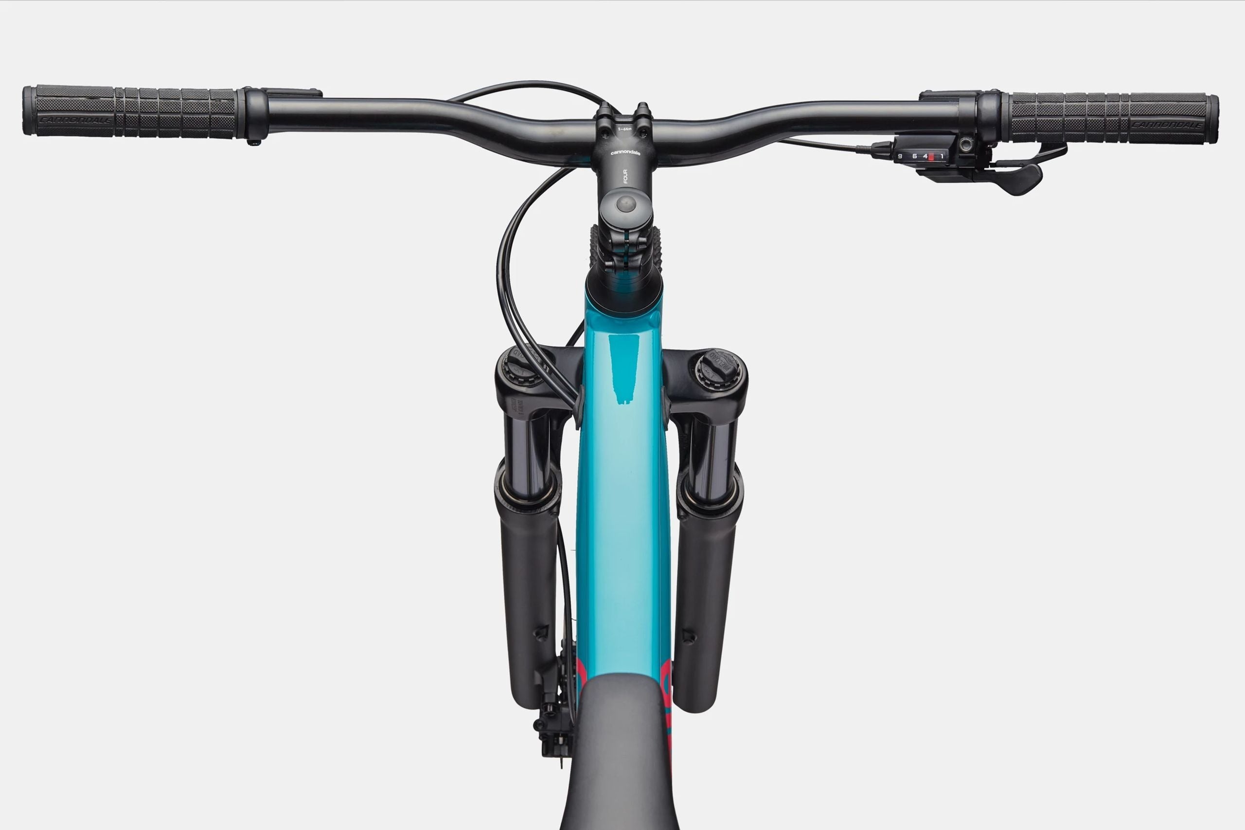 Close-up of a mountain bike handlebar and front fork with a white background