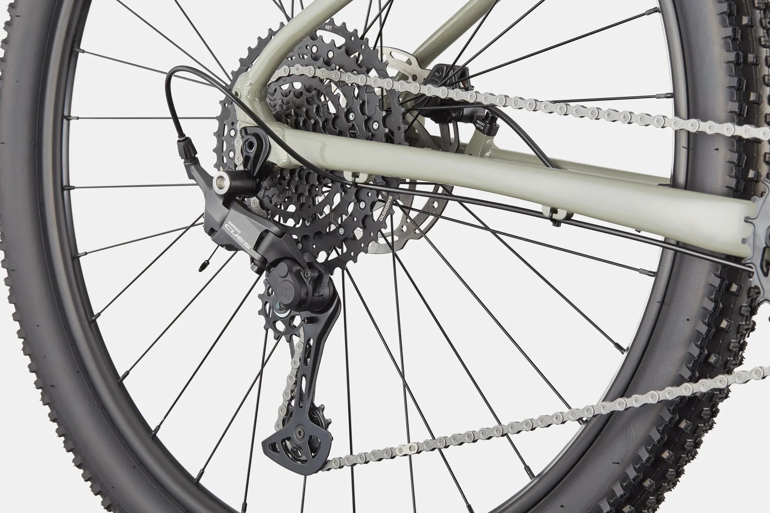 Close-up of a bicycle's rear wheel and gear system on a white background