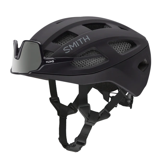 Black Smith road bike helmet with sunglasses mounted on front of helmet on a white background