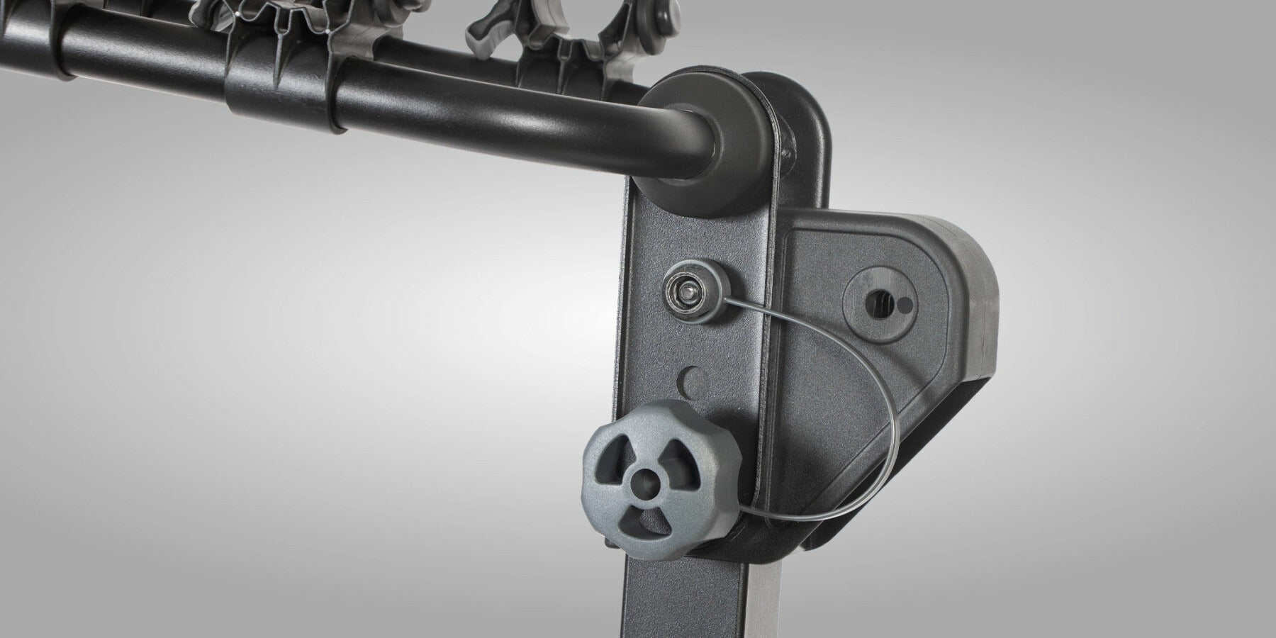 Close up of a bike rack folding mechanism on a gray background