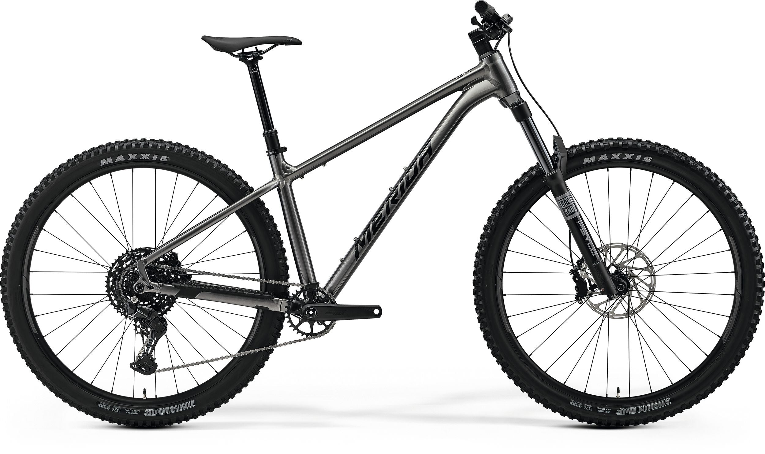 Silver Merida mountain bike with thick black tyres on a white background
