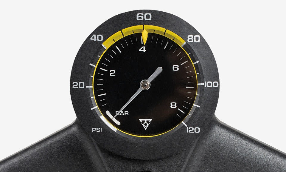 Close-up of a bicycle pump pressure gauge with a black and yellow design on a white background