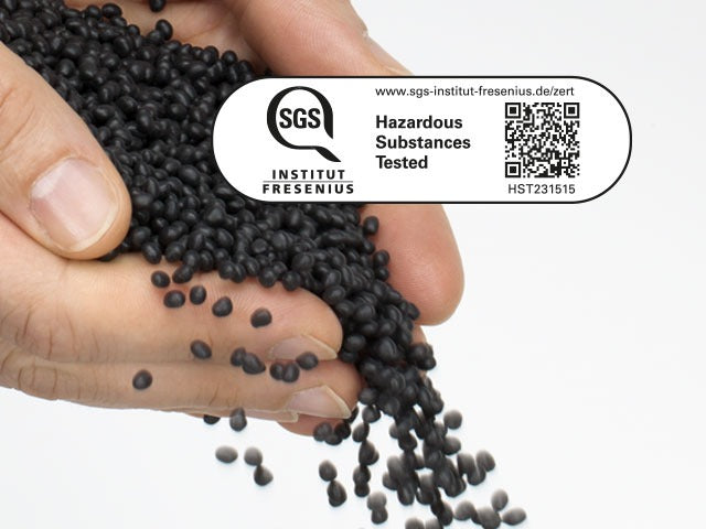 Hand holding black pellets with SGS Institut Fresenius logo and text on a white background