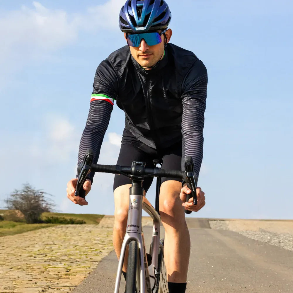 Cyclist riding on a road with a clear sky