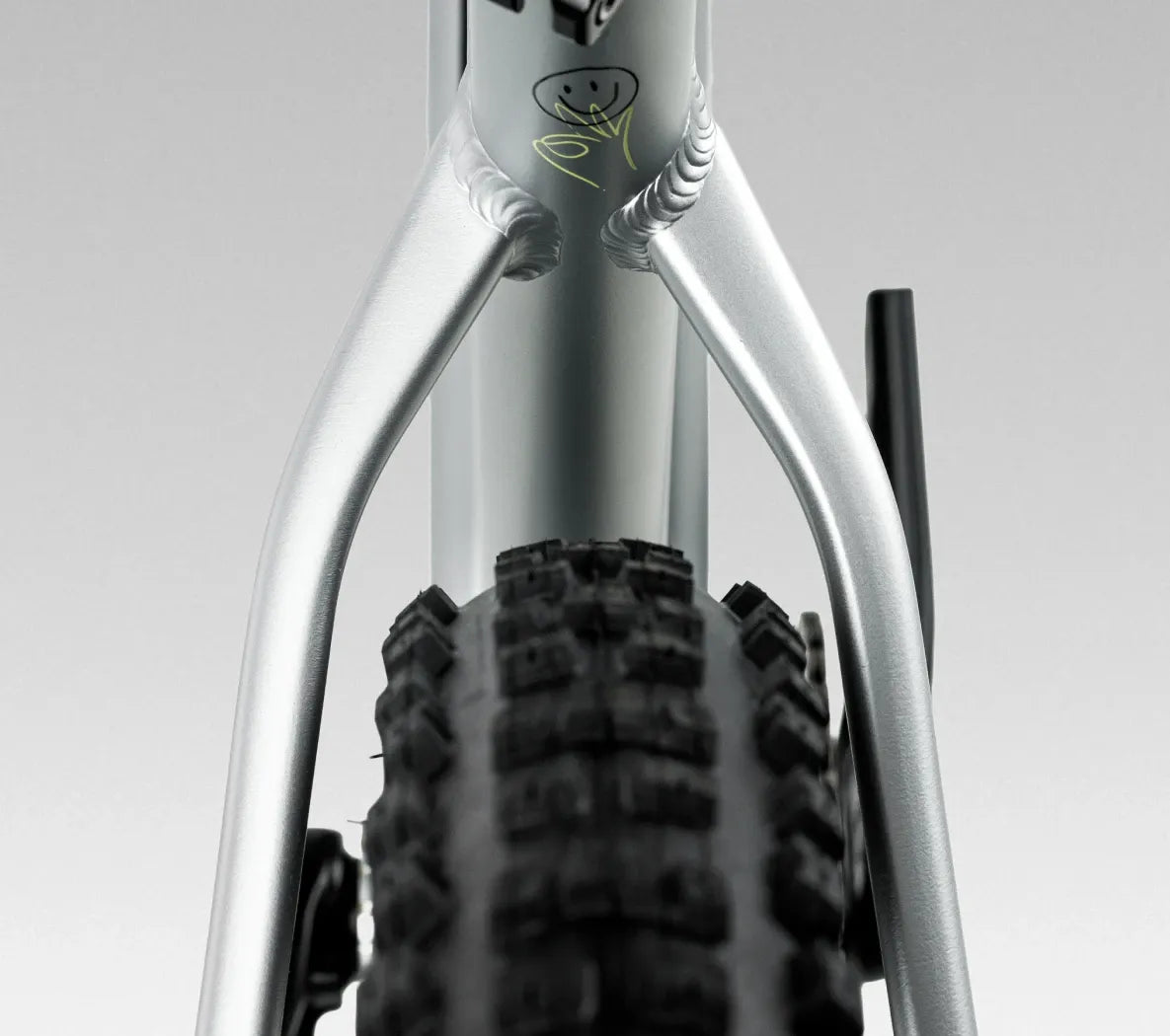 Close-up of a silver mountain bike Seat Stays with a blurred background