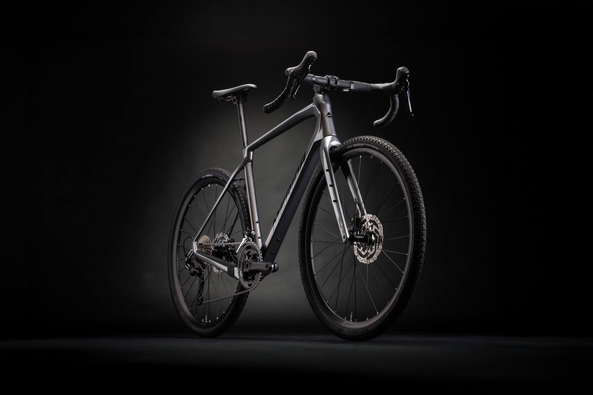 Grey Merida Gravel Bike against a black background