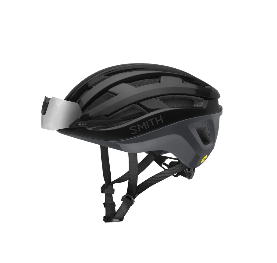 Black road bike helmet with 'Smith' branding with sunglasses tucked in on the front on a white background