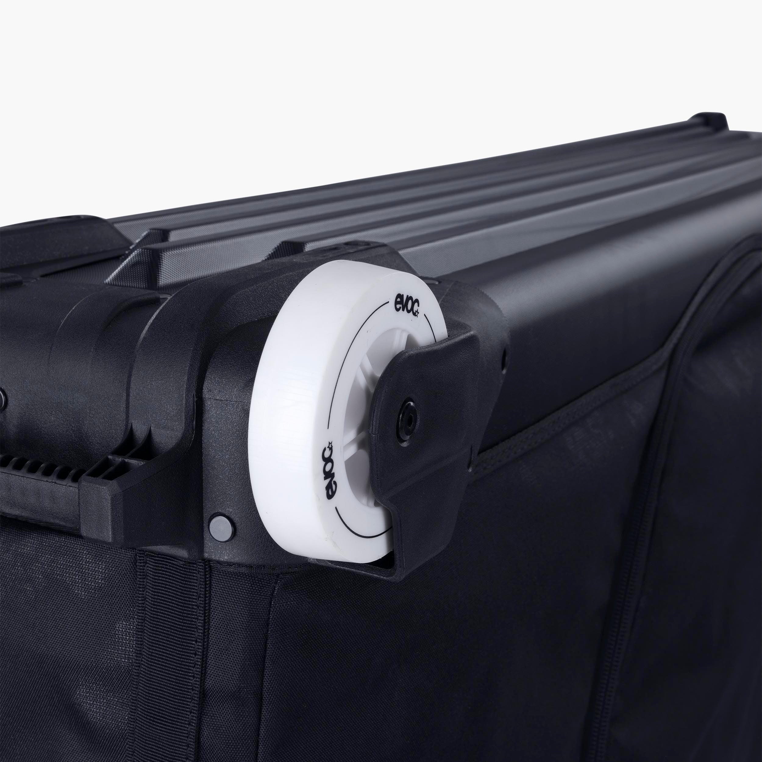 A close up of the wheels on an EVOC Bike Bag with a visible brand logo on a white background