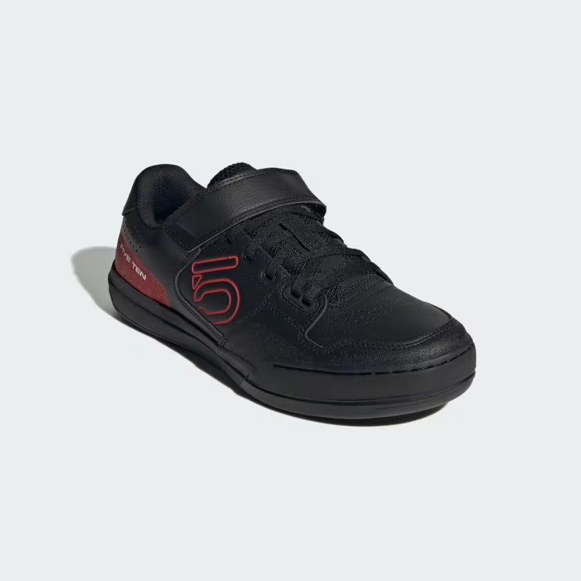 A black mountain bike shoe with a hook-and-loop strap closure, featuring a red outlined '5' logo on the side and a red heel accent, shown on a light gray background.