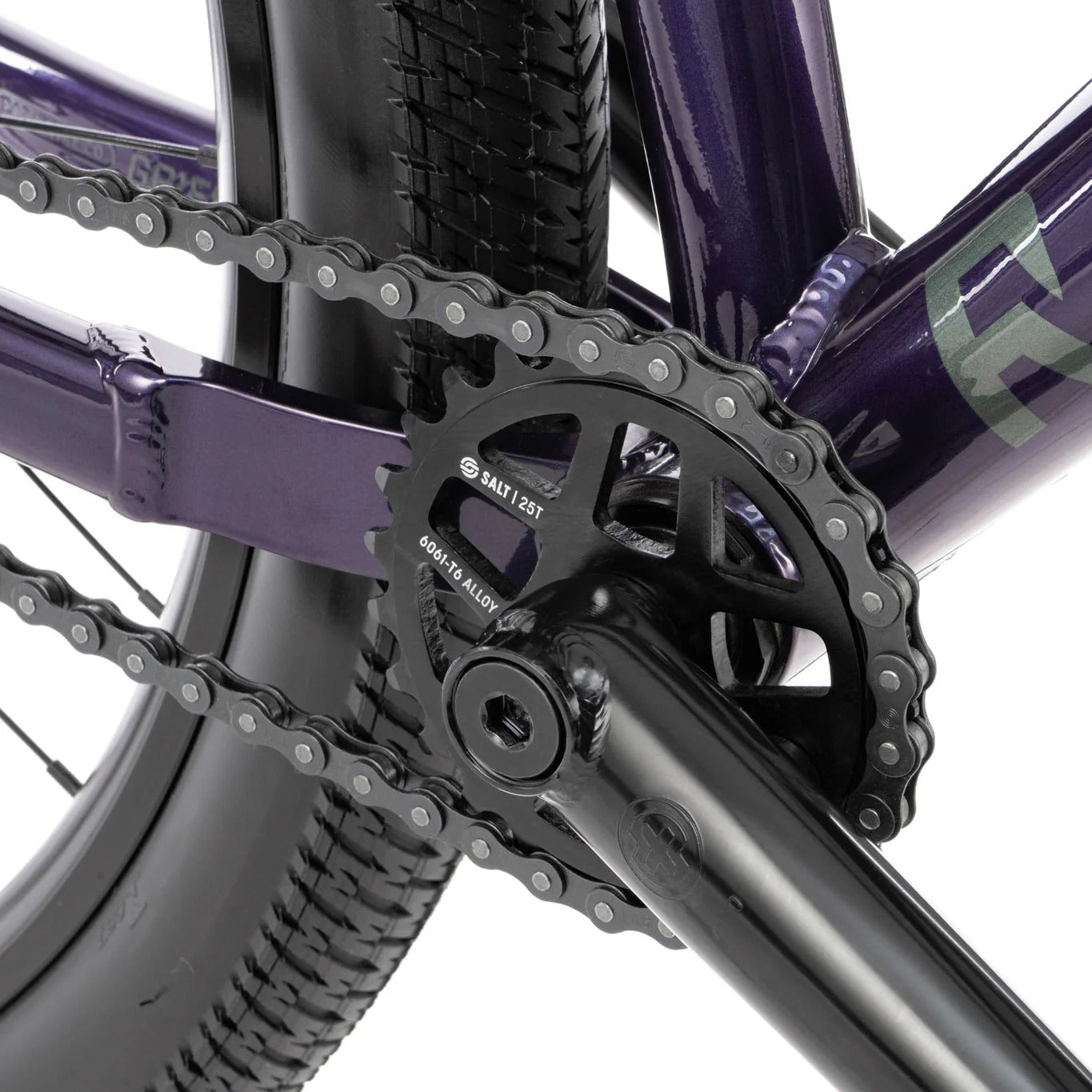 Close-up of a bicycle chain and gear system on a white background