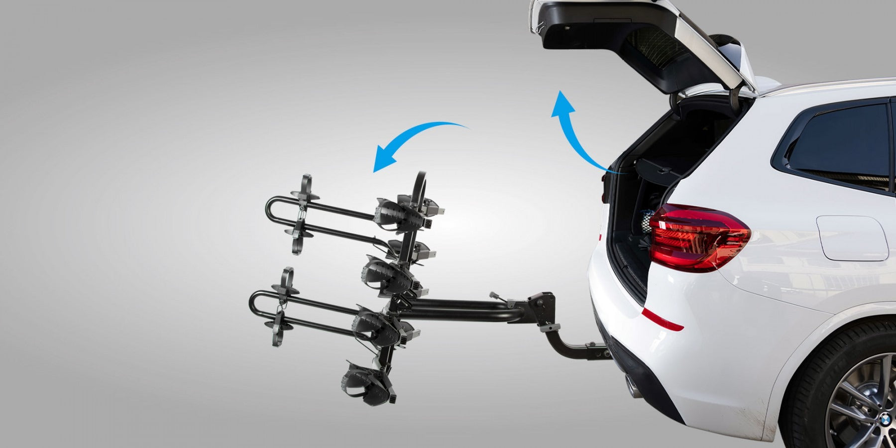 Car with a bike rack attached and showing the tilting function to access the boot on a gray background