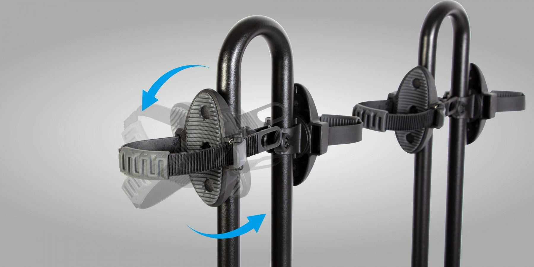 Black metal bike rack with adjustable straps on a gray background
