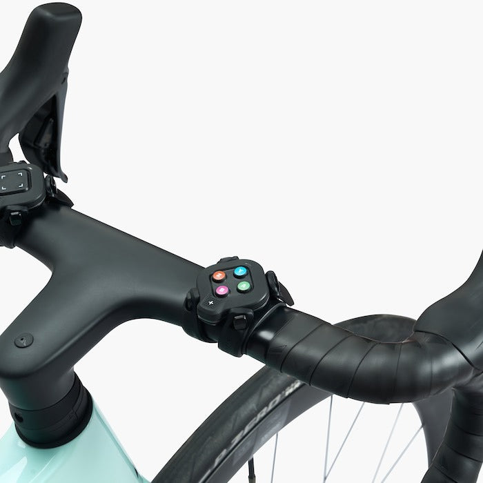 Close-up of a bicycle handlebar with control device on a white background