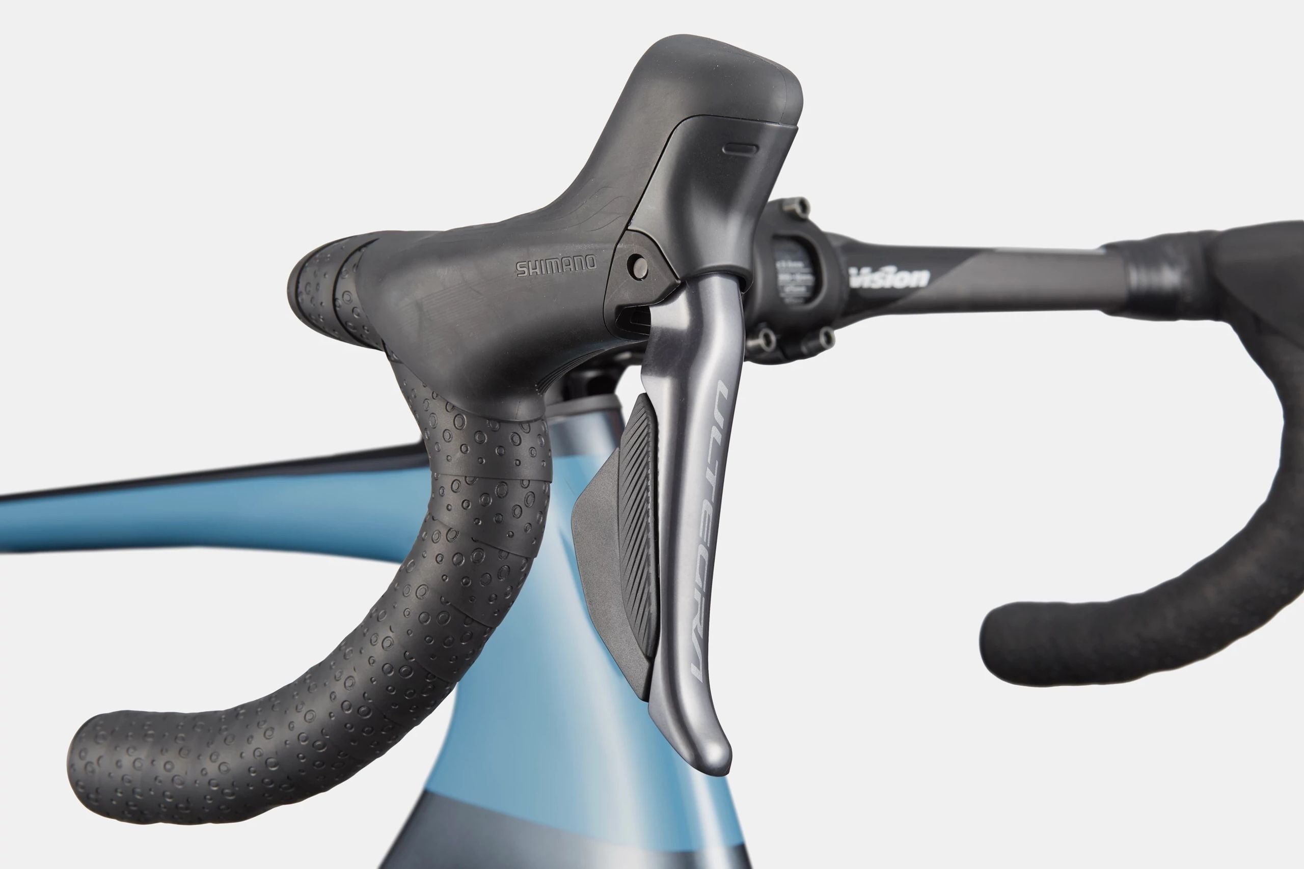 Close-up of road bike handlebars with a blurred background
