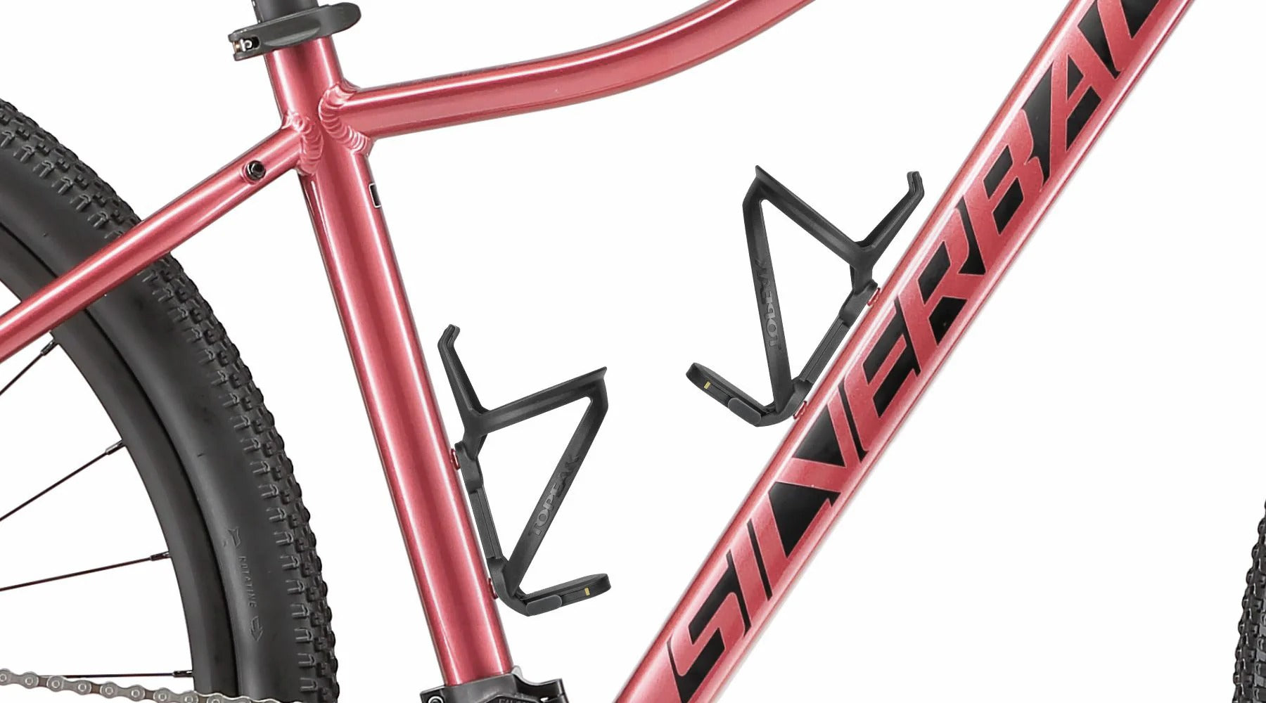 A close up of the bottle cages on a pinky red ladies mountain bike with a white background