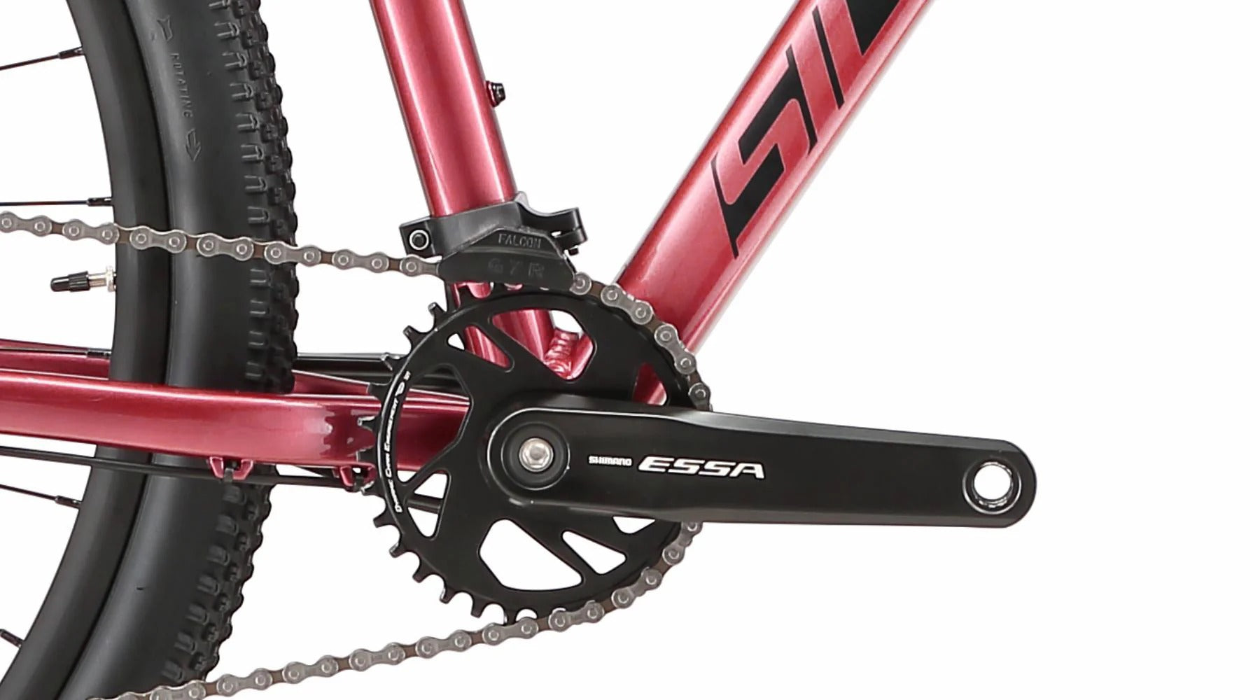 A close up of the front chainring on a pinky red ladies mountain bike with a white background