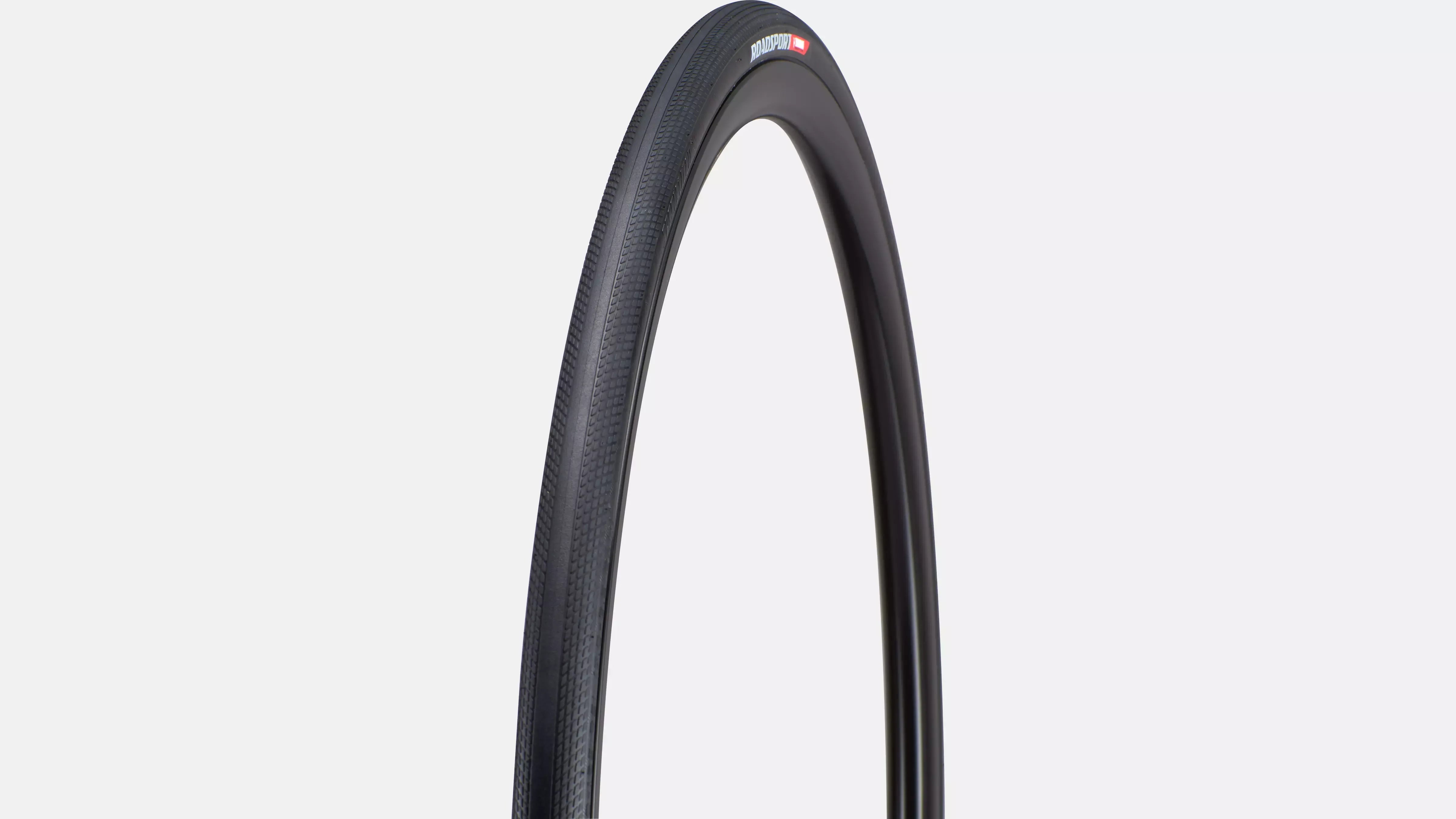 Road cycling tyre on a light gray background