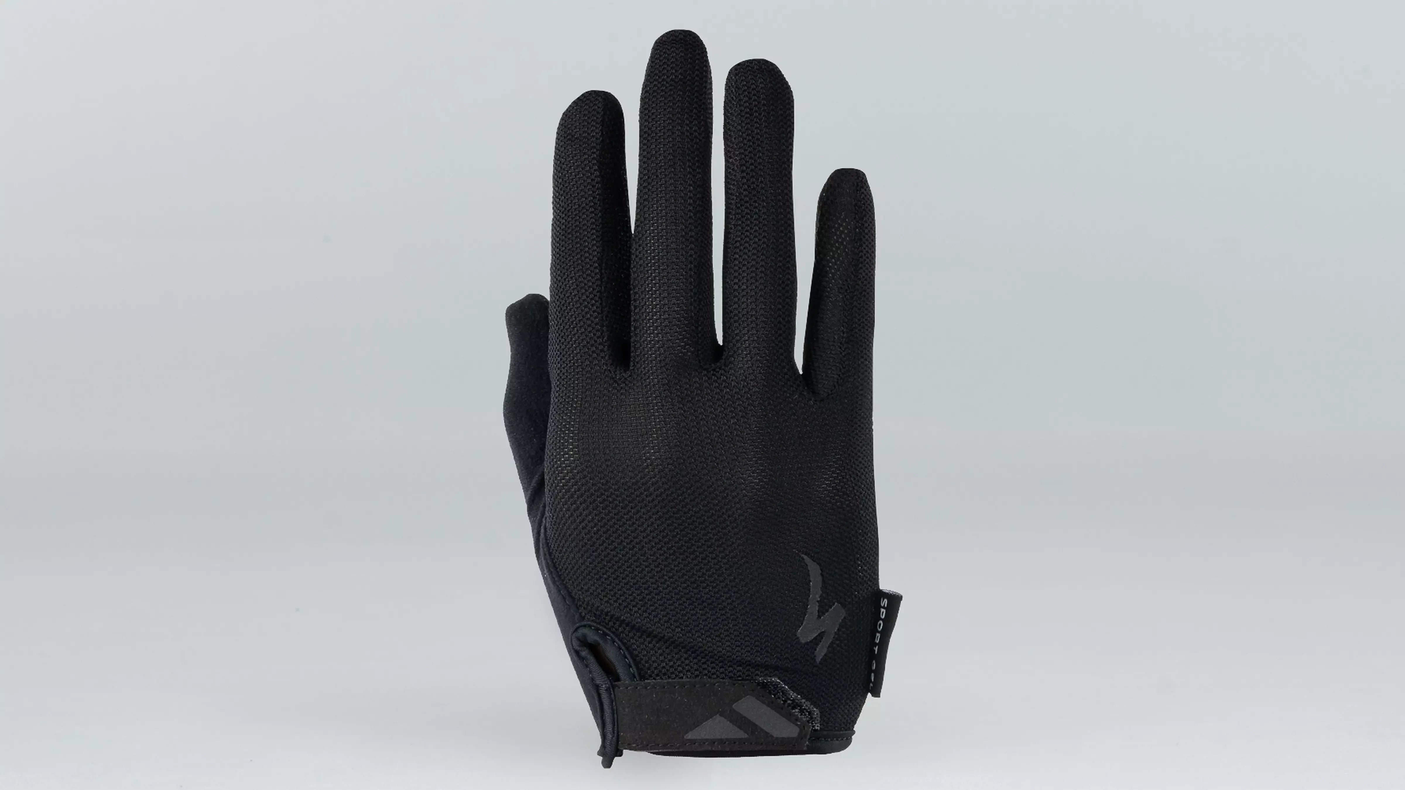 Black full fingered bicycle glove against a grey background