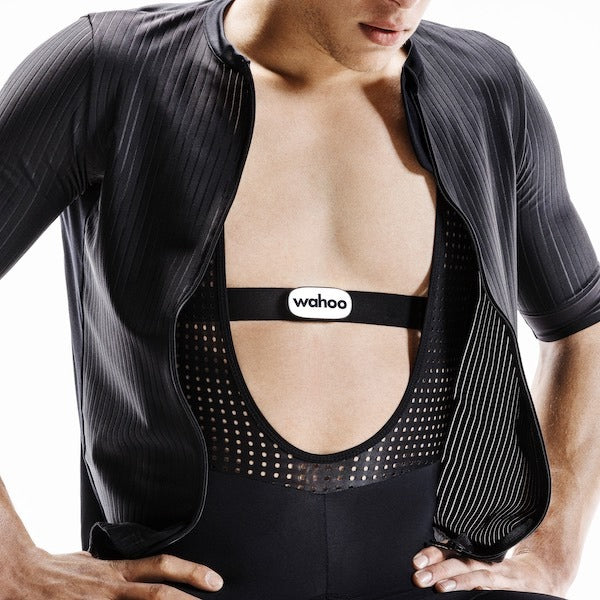 Person wearing a black heart rate monitor strap with a visible 'wahoo' brand logo.