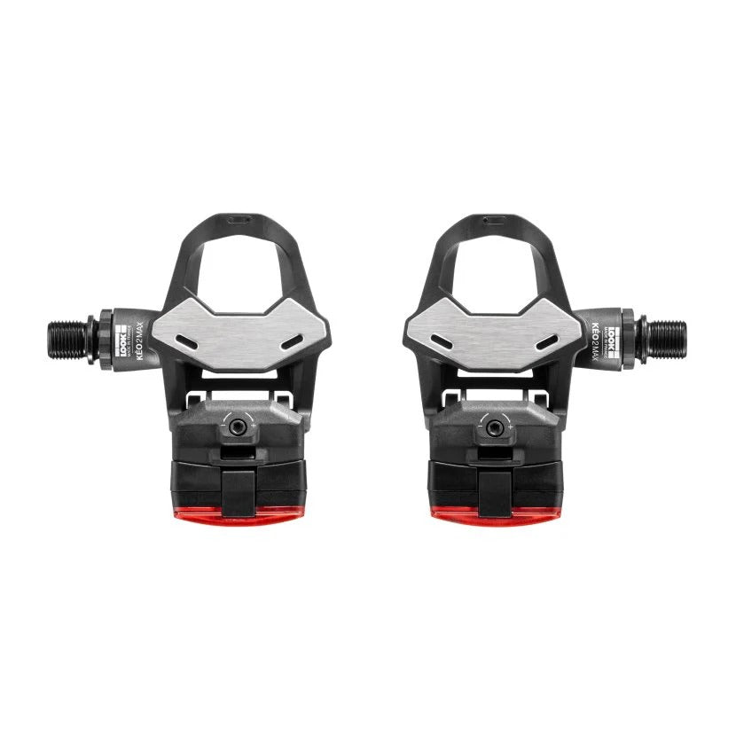 Pair of bicycle pedals with red lights on the back of each pedal on a white background
