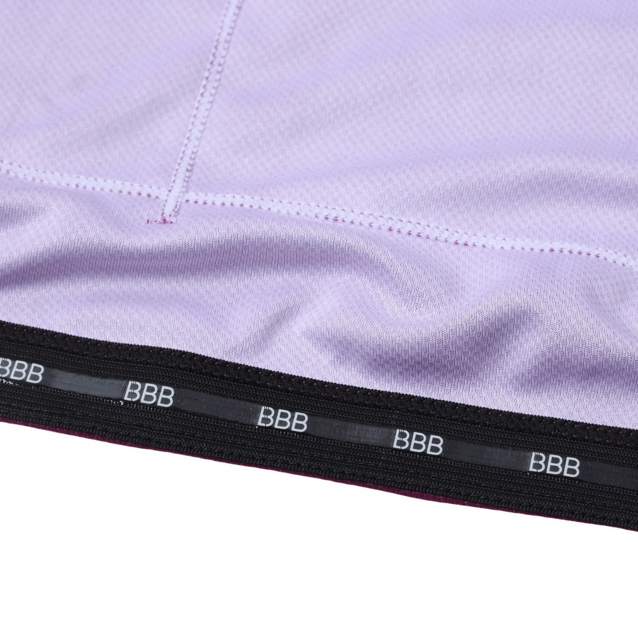 Close-up of a purple cycling jersey with 'BBB' branding on a black band.