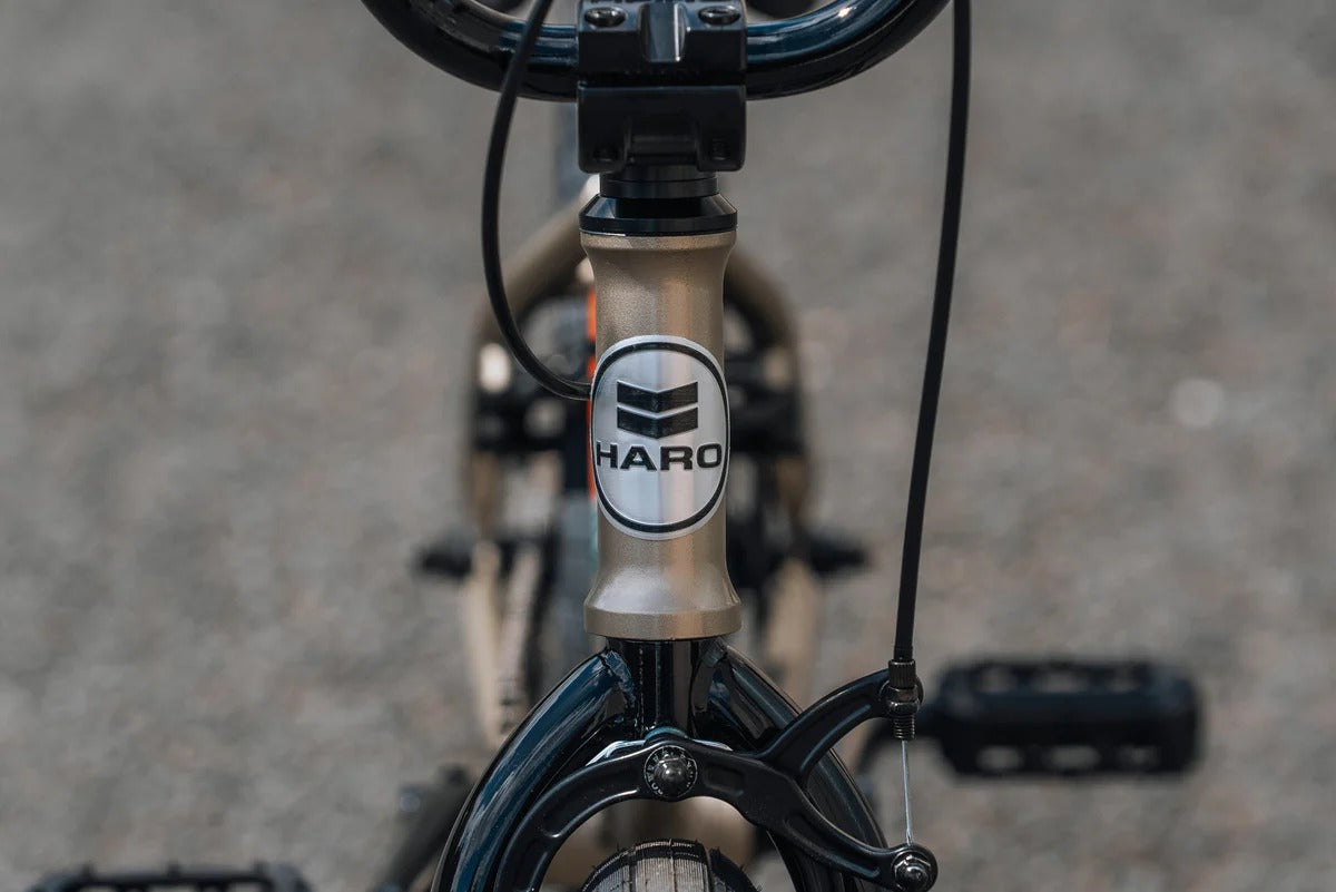 Close-up of a BMX Bike's front suspension fork with Haro branding on a blurred background