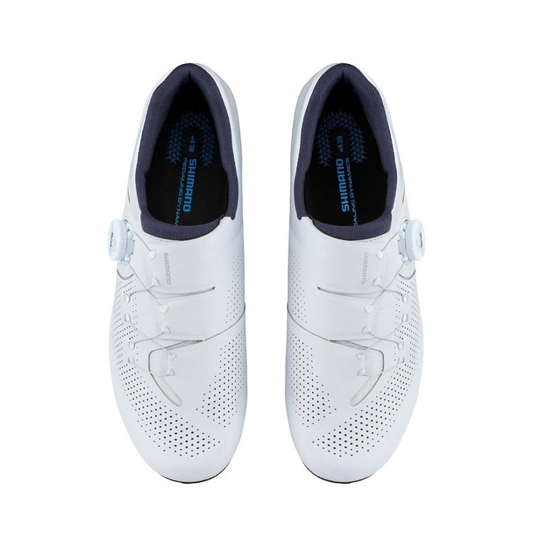 Pair of white Shimano cycling shoes with blue lining on a white background