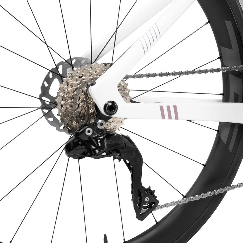 Close-up of a bicycle wheel with gear and chain on a white background