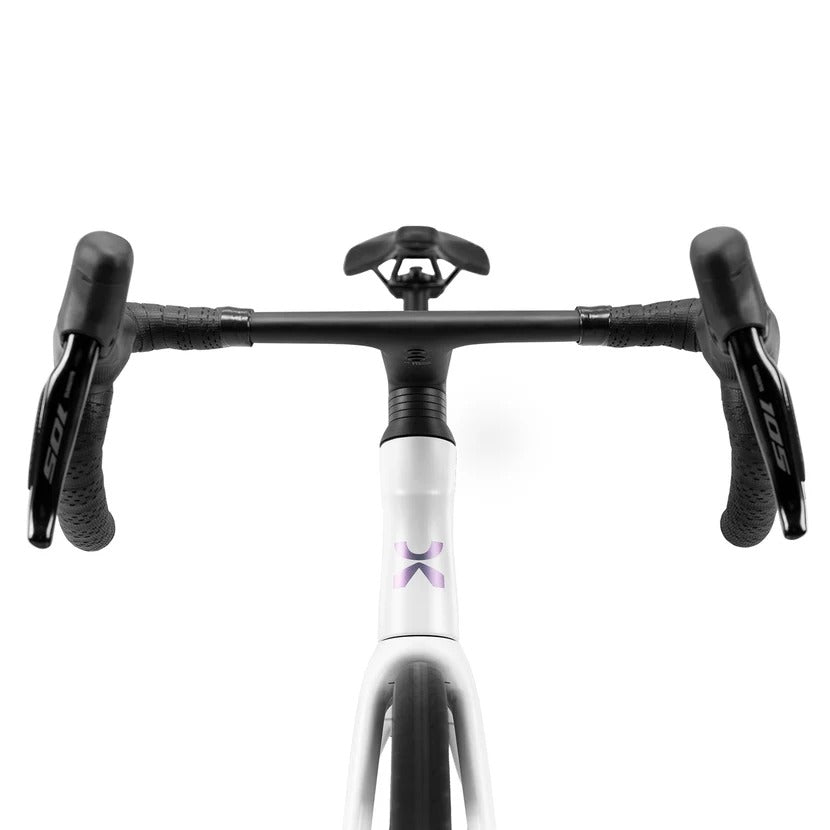 Front view of a road bicycle handlebar and frame area on a clean white background. The bike has a white down tube with a small purple logo, black handlebars, black grips, and black Shimano 105 components.