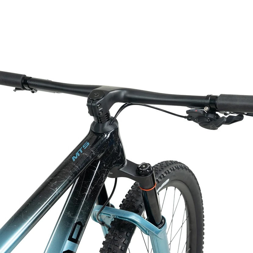 Close up of a black and blue glossy mountain bike handlebar and  part of the frame with the model 'MT5' printed on the frame on a white background
