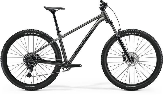 A silver Merida hardtail mountain bike on a white background