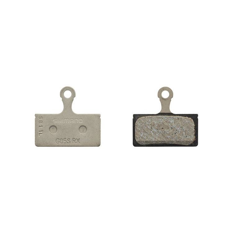 Two disc brake pads with 'Shimano' branding on a white background