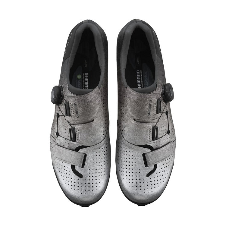 Pair of silver mountain bike cycling shoes with black accents on a white background