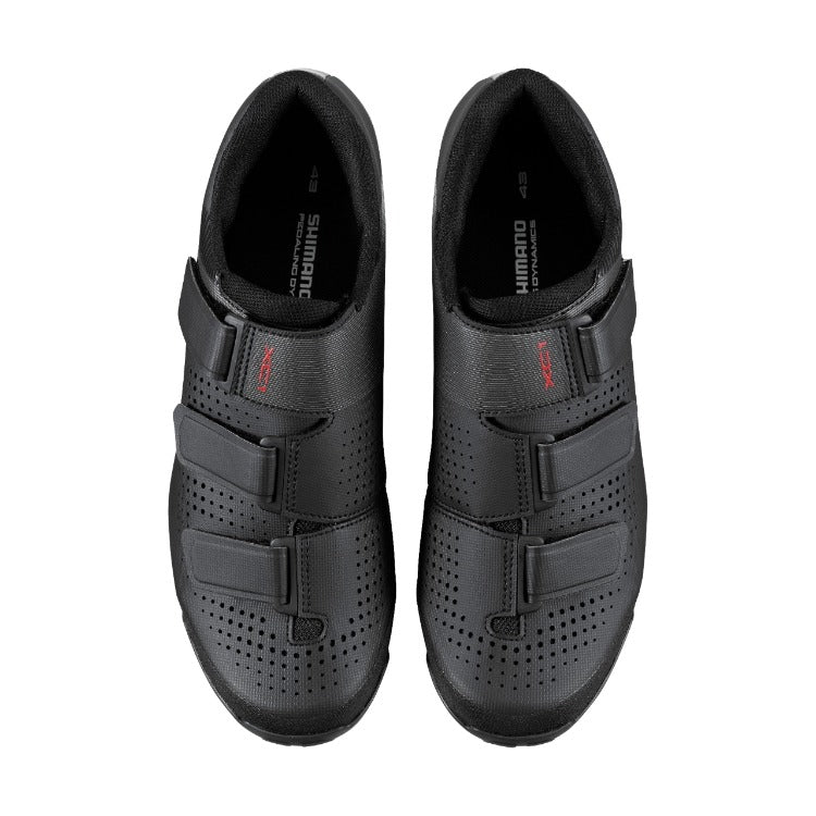 Pair of black Mountain bike shoes with Shimano branding on a white background
