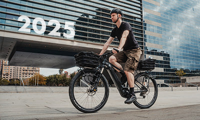 A picture of someone riding a bike with the Topeak Topeak Uni Super Tourist DX (Disc) 24-29" Pannier Rack