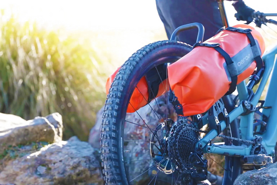 A close up picture of the Aeroe Spider Rear Bicycle Rack with a bag on the back of a mountain bike